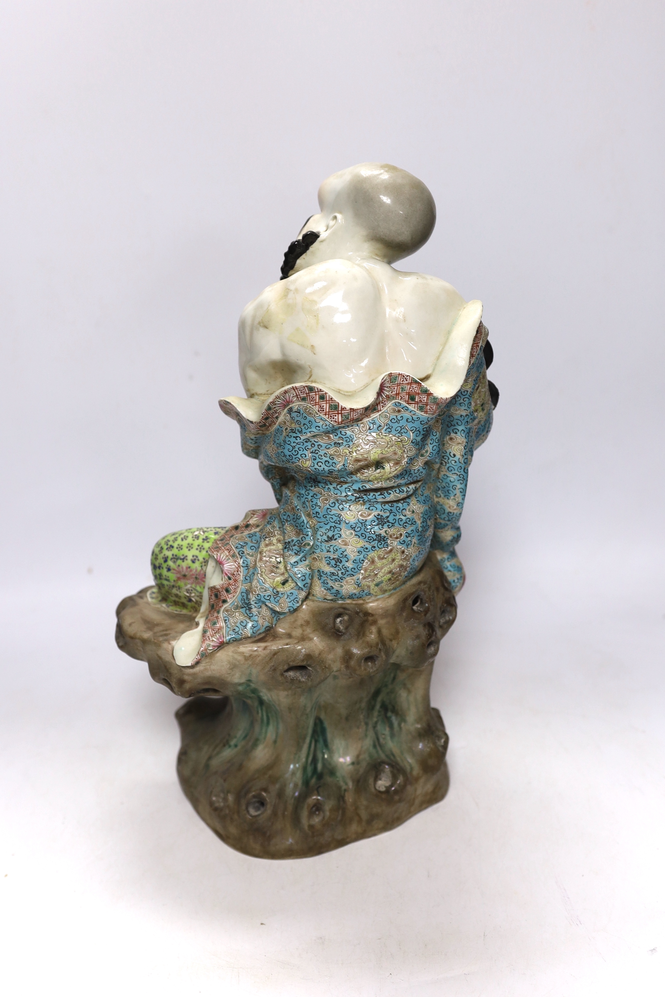 A Chinese enamelled porcelain figure of a luohan, 38cm high